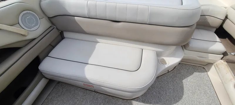 Slide: The Image of 2002 Sea Ray 220 Bow Rider interior seating with light gray upholstery. - 34