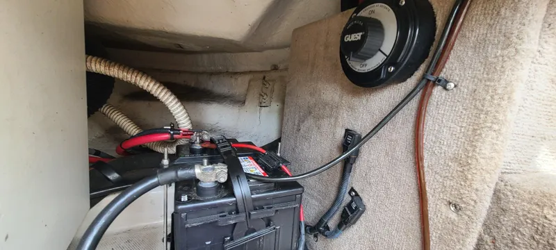Slide: The Image of Battery compartment of a 2002 Sea Ray 220 Bow Rider boat with wiring and charger. - 47