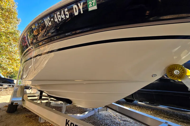 Slide: The Image of 2002 Sea Ray 220 Bow Rider on trailer, close-up view of hull and registration. - 5