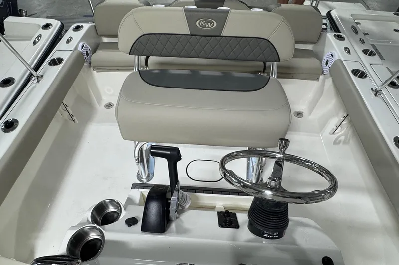 Slide: The Image of 2026 Key West 189 FS boat interior with steering wheel and seating. - 11