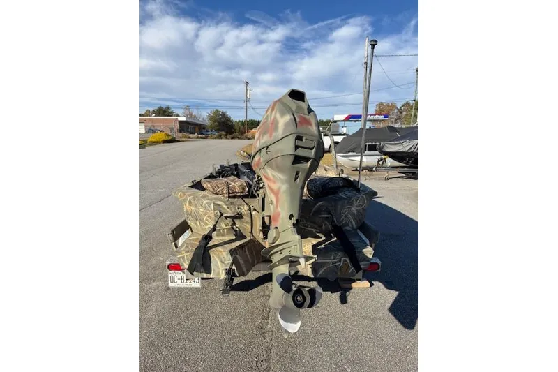 Slide: The Image of 2018 War Eagle 750 Gladiator boat with camouflage design and outboard motor. - 5