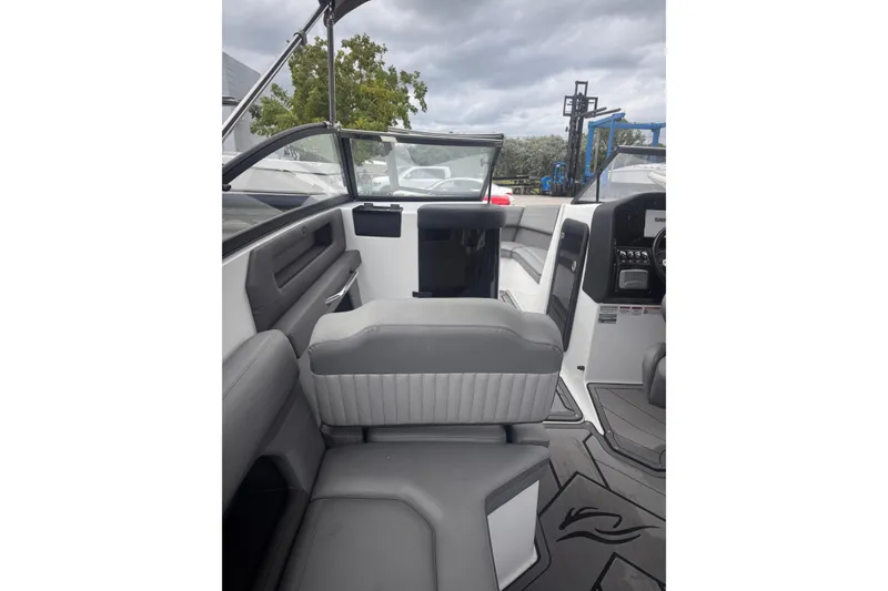 Slide: The Image of 2020 Rinker Q3 OB boat interior with gray seating and modern dashboard design. - 16