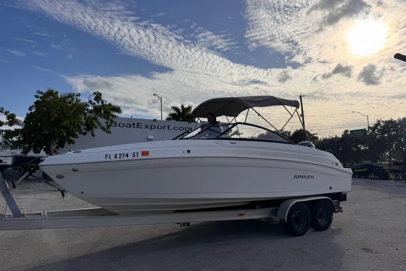 Slide: The Image of 2020 Rinker Q3 OB boat on trailer under cloudy sky. - 18