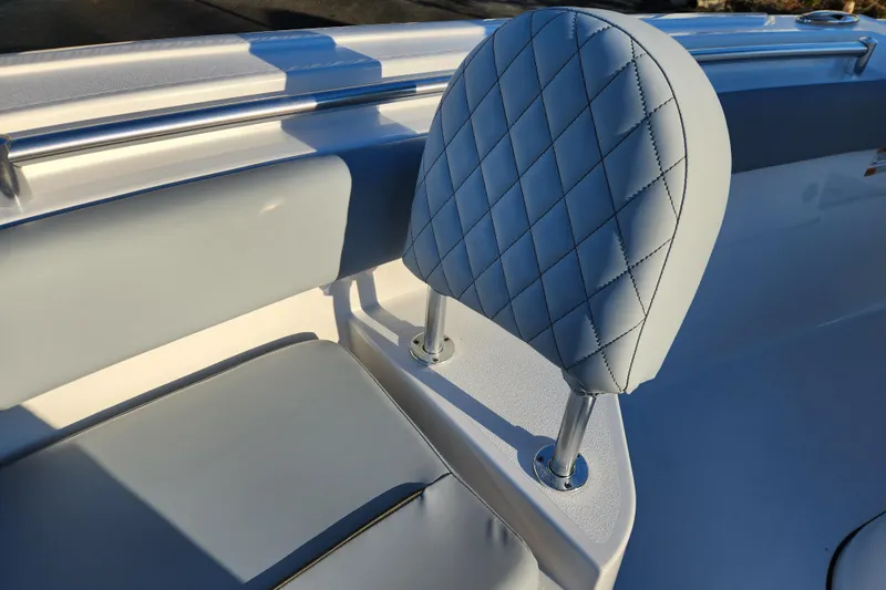 Slide: The Image of 2026 Sportsman Heritage 231 Center Console boat seat with quilted design and stainless steel supports. - 12