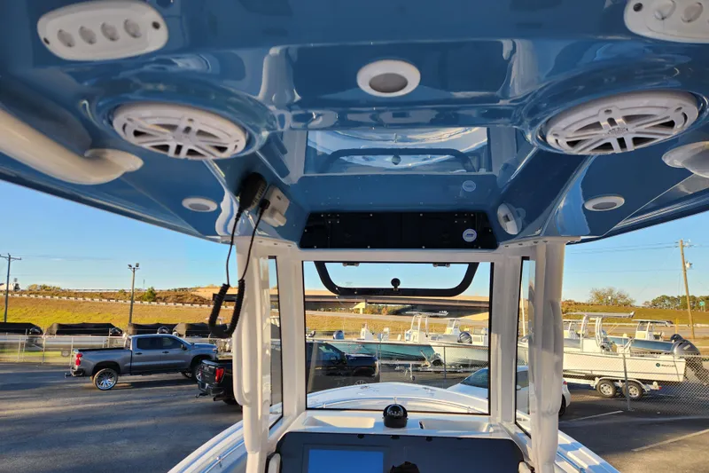 Slide: The Image of 2026 Sportsman Heritage 231 Center Console boat interior with speakers and control panel. - 21