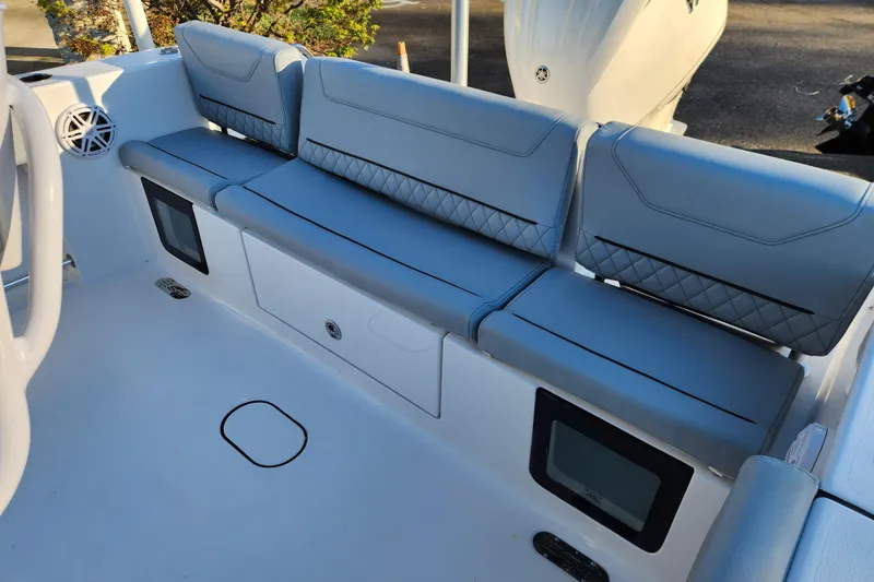 Slide: The Image of 2026 Sportsman Heritage 231 Center Console boat seating area with storage compartments. - 26