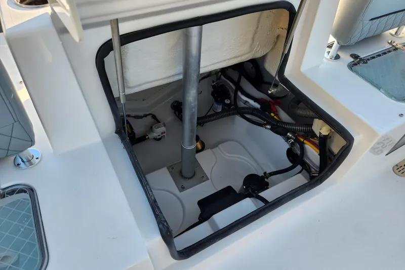 Slide: The Image of 2026 Sportsman Heritage 231 Center Console boat interior compartment with wiring and components. - 27