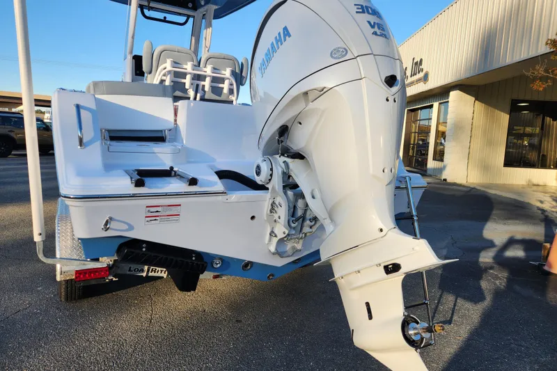 Slide: The Image of 2026 Sportsman Heritage 231 Center Console boat with Yamaha 300 engine, parked outdoors. - 3
