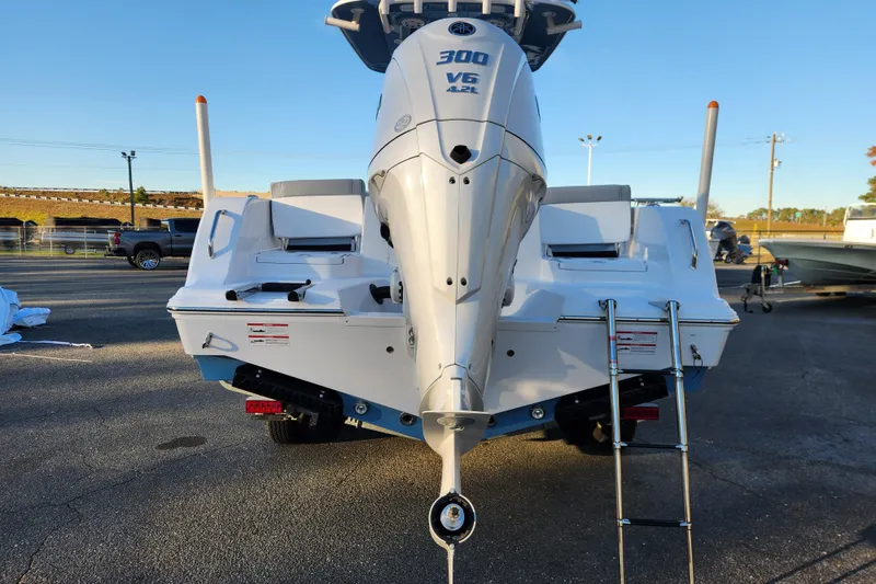 Slide: The Image of 2026 Sportsman Heritage 231 Center Console boat with powerful V6 engine, rear view. - 4