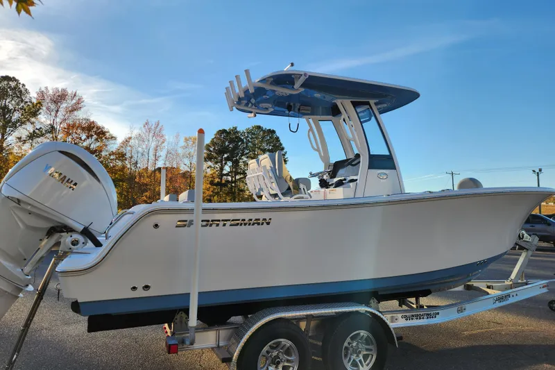 Slide: The Image of 2026 Sportsman Heritage 231 Center Console boat on trailer, side view, clear sky background. - 5