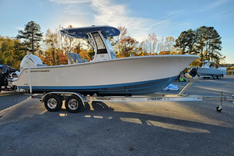 Slide: The Image of 2026 Sportsman Heritage 231 Center Console boat on trailer, parked outdoors. - 6