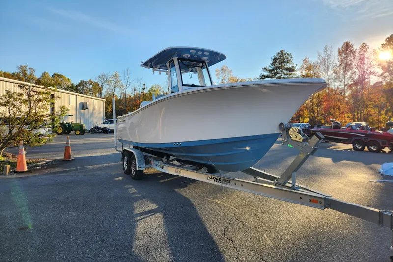 Slide: The Image of 2026 Sportsman Heritage 231 Center Console boat on trailer in parking lot. - 7