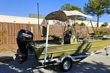 Slide: The Image of 2021 Lowe Roughneck 1860CC boat with canopy and Mercury outboard motor. - 11