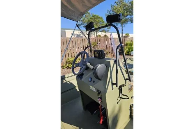 Slide: The Image of 2021 Lowe Roughneck 1860CC boat console with steering wheel and controls. - 13