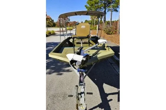 Slide: The Image of 2021 Lowe Roughneck 1860CC boat on trailer, parked outdoors. - 14