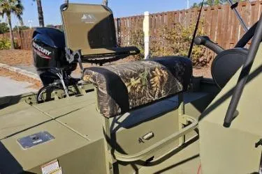 Slide: The Image of 2021 Lowe Roughneck 1860CC boat with canopy and Mercury outboard motor on trailer. - 3