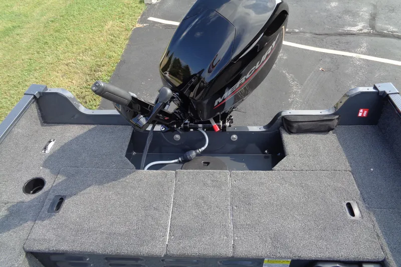 Slide: The Image of 2026 Lund 1650 Angler Tiller boat with Mercury outboard motor, carpeted deck. - 11