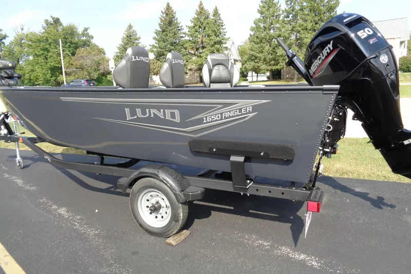Slide: The Image of 2026 Lund 1650 Angler Tiller boat on trailer with Mercury outboard motor. - 2