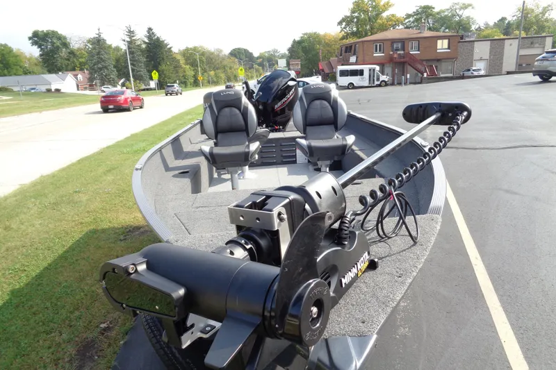 Slide: The Image of 2026 Lund 1650 Angler Tiller boat with Minn Kota trolling motor on a street. - 9