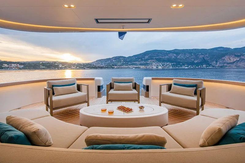 Slide: The Image of Luxurious yacht deck with elegant seating, ocean view, and sunset; Van der Valk Custom 34M Explorer 2021. - 9