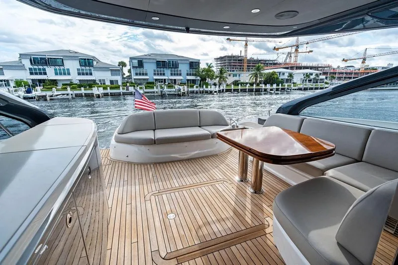 Slide: The Image of Luxurious 2021 Princess V55 yacht interior with elegant seating and waterfront view. - 13