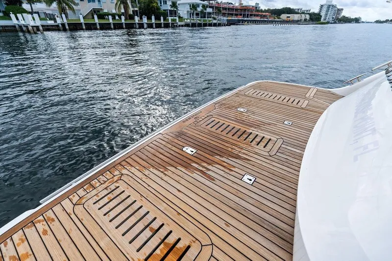 Slide: The Image of Teak deck of 2021 Princess V55 yacht by the water. - 21