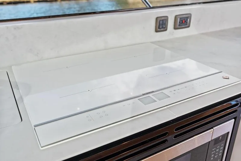 Slide: The Image of Modern kitchen appliance on 2021 Princess V55 yacht, featuring sleek design and advanced controls. - 32