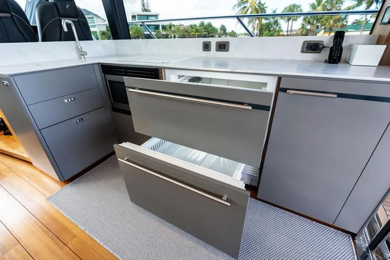 Slide: The Image of Modern kitchen on 2021 Princess V55 yacht with sleek cabinetry and open drawers. - 33