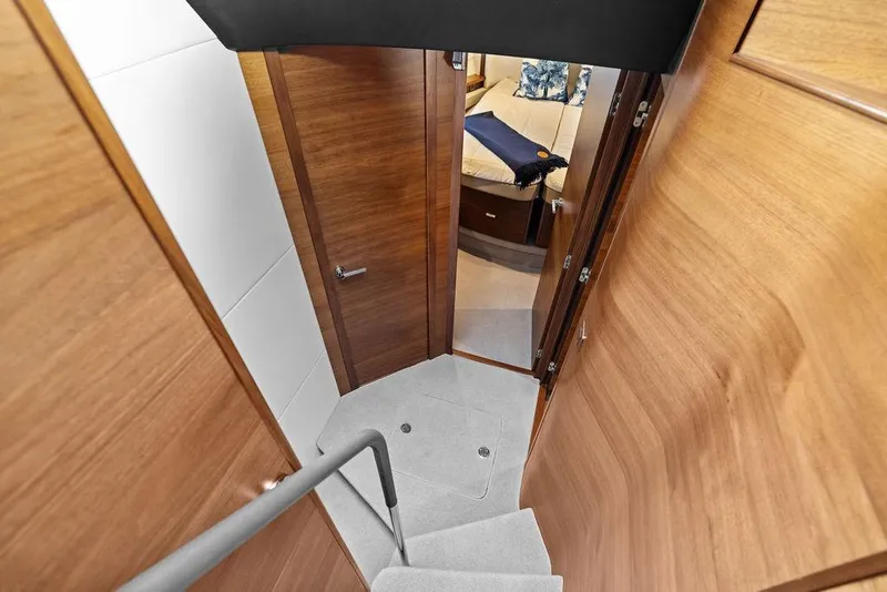 Slide: The Image of Interior view of 2021 Princess V55 yacht, featuring wooden doors and cozy cabin space. - 34