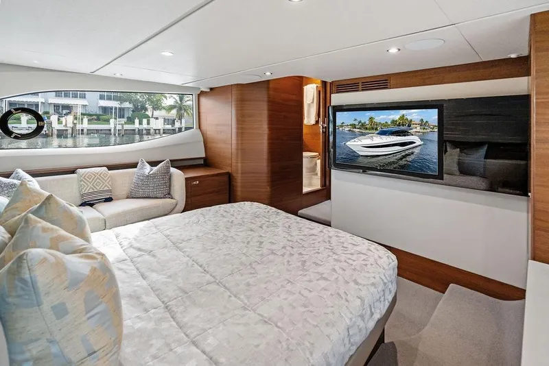 Slide: The Image of Luxurious 2021 Princess V55 yacht interior with cozy bedroom and scenic window view. - 36