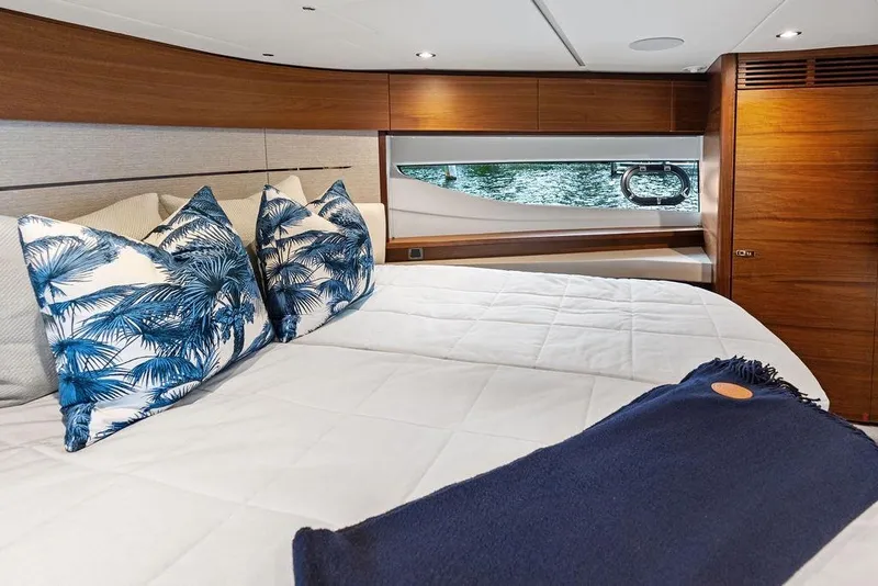 Slide: The Image of Luxurious 2021 Princess V55 yacht bedroom with elegant decor and scenic window view. - 42