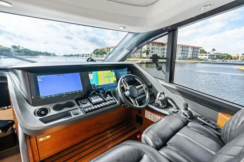 Slide: The Image of Luxurious 2021 Princess V55 yacht cockpit with advanced navigation systems and leather seating. - 51