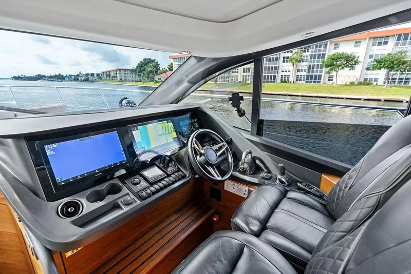 Slide: The Image of Luxurious 2021 Princess V55 yacht cockpit with advanced navigation systems and leather seating. - 54