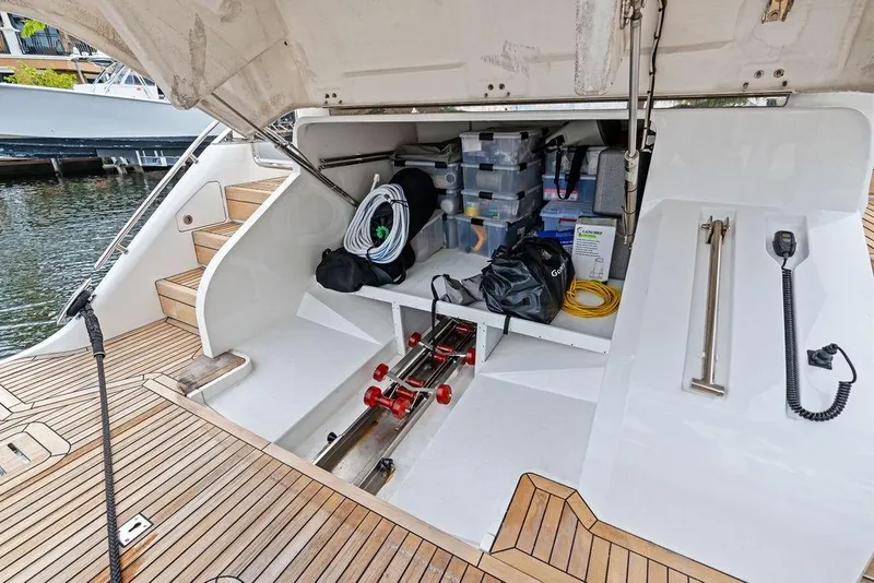 Slide: The Image of Storage compartment of a 2021 Princess V55 yacht, featuring organized equipment and accessories. - 55