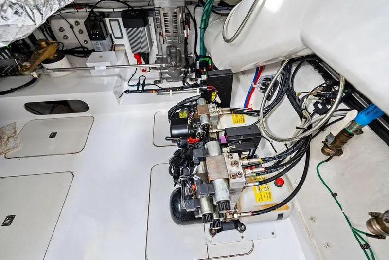 Slide: The Image of Engine room of 2021 Princess V55 yacht, showcasing mechanical components and wiring. - 59