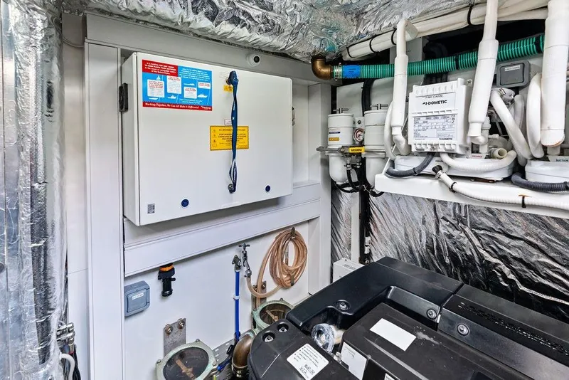 Slide: The Image of Engine room of 2021 Princess V55 yacht with control panels and piping. - 65