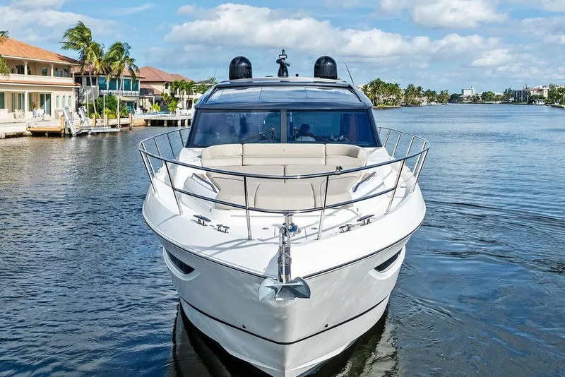 Slide: The Image of 2021 Princess V55 yacht cruising on a sunny waterfront with palm trees. - 8