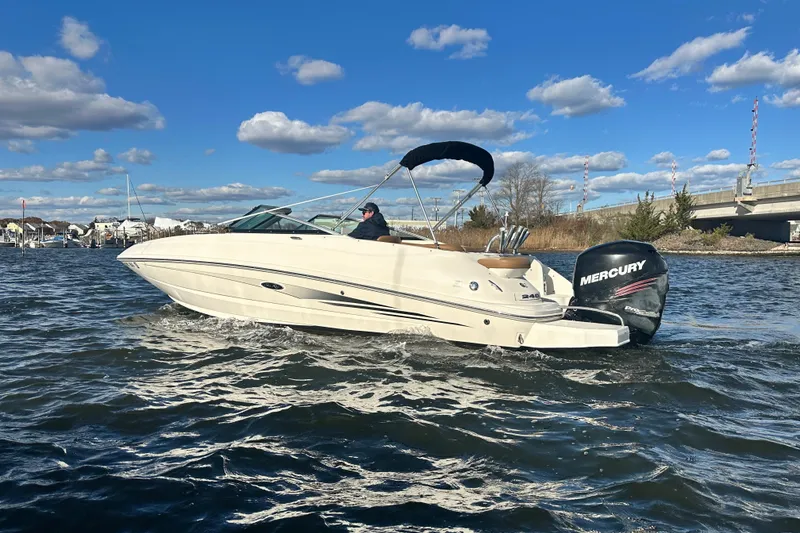 Slide: The Image of 2014 Sea Ray 240 Sundeck Outboard cruising on a sunny day with clear skies. - 1