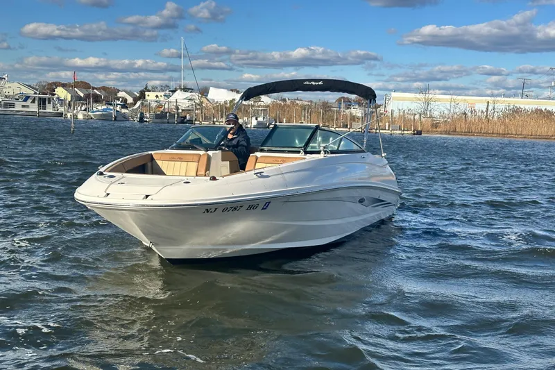 Slide: The Image of 2014 Sea Ray 240 Sundeck Outboard boat cruising on a sunny day. - 12