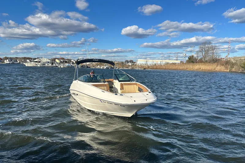 Slide: The Image of 2014 Sea Ray 240 Sundeck Outboard cruising on a sunny day with blue skies. - 14