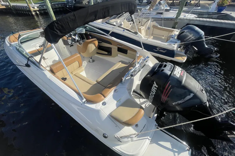 Slide: The Image of 2014 Sea Ray 240 Sundeck Outboard boat docked, featuring Mercury 250 Pro engine. - 16