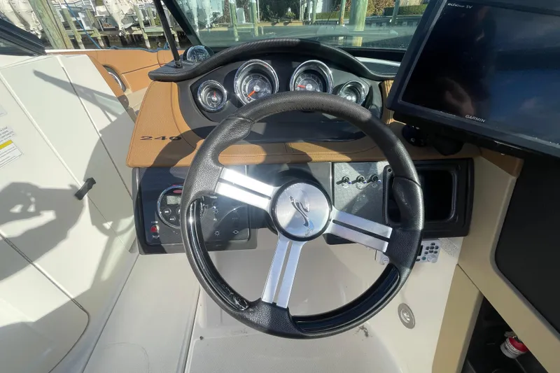 Slide: The Image of Steering wheel and dashboard of 2014 Sea Ray 240 Sundeck Outboard boat. - 19