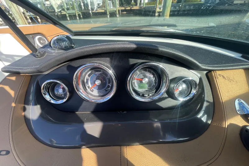 Slide: The Image of Dashboard of 2014 Sea Ray 240 Sundeck Outboard with gauges and compass. - 22