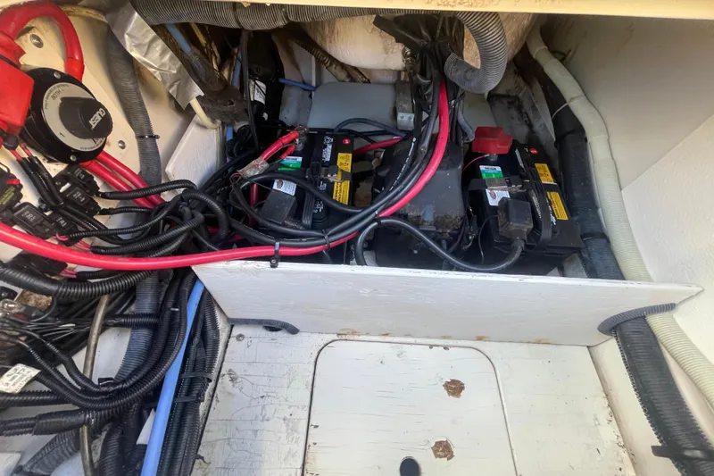Slide: The Image of 2014 Sea Ray 240 Sundeck Outboard battery compartment with cables and wiring. - 29