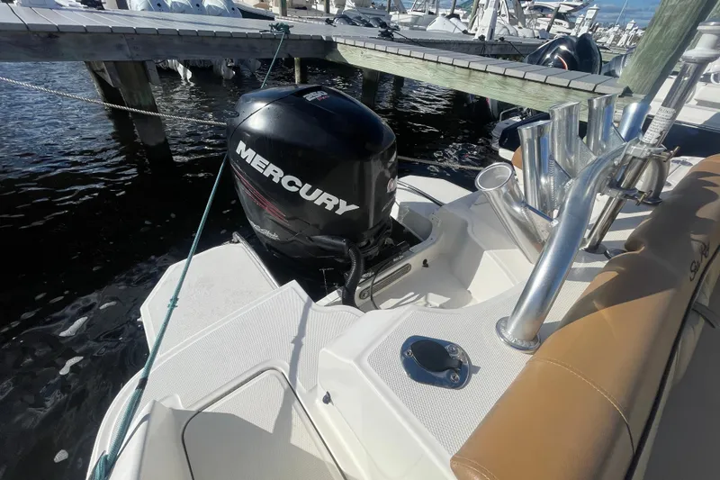 Slide: The Image of 2014 Sea Ray 240 Sundeck Outboard with Mercury engine docked at marina. - 30