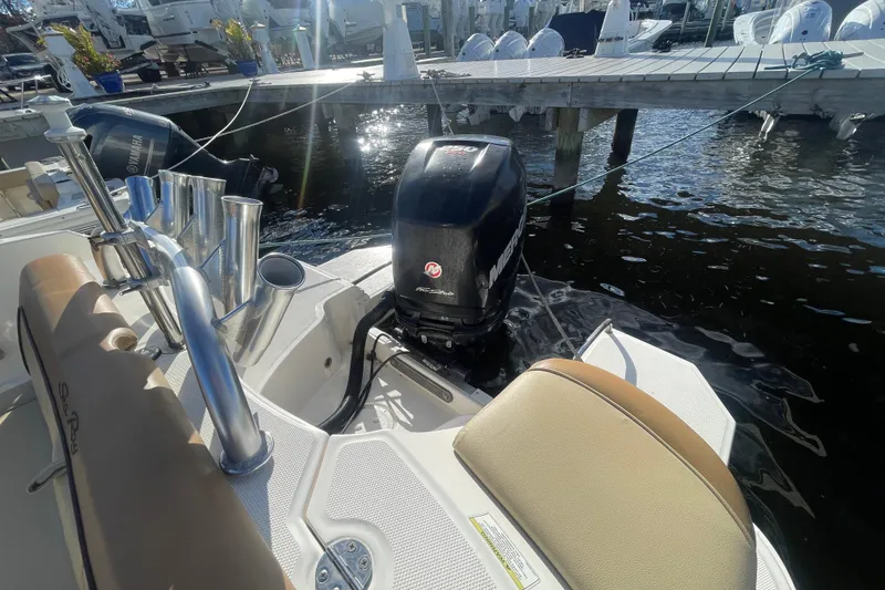 Slide: The Image of 2014 Sea Ray 240 Sundeck Outboard docked, featuring a powerful Mercury engine. - 31