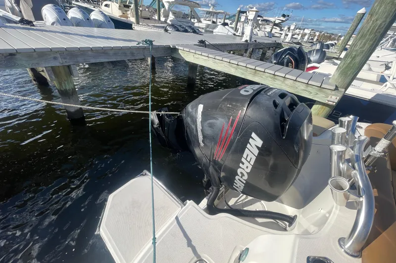 Slide: The Image of 2014 Sea Ray 240 Sundeck Outboard with Mercury engine docked at marina. - 33