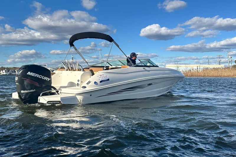 Slide: The Image of 2014 Sea Ray 240 Sundeck Outboard boat cruising on a sunny day. - 5