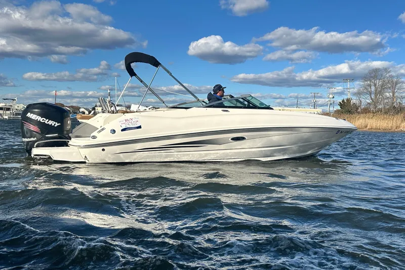 Slide: The Image of 2014 Sea Ray 240 Sundeck Outboard boat cruising on a sunny day. - 6
