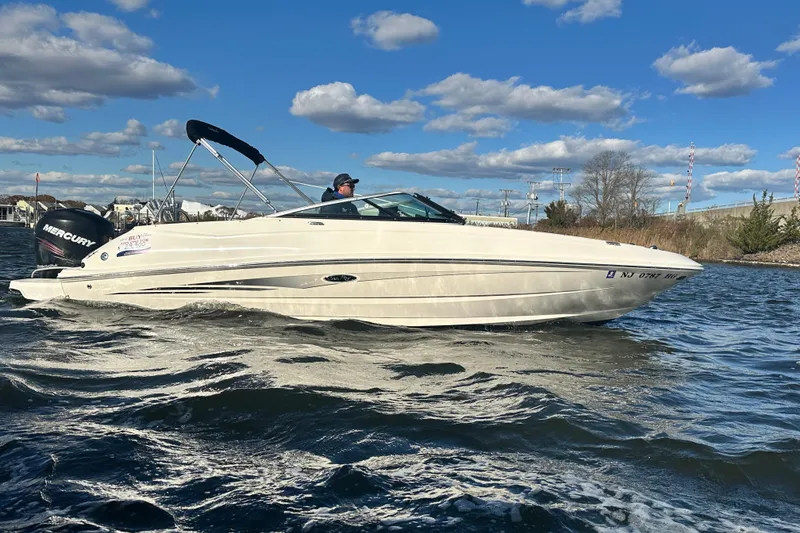 Slide: The Image of 2014 Sea Ray 240 Sundeck Outboard cruising on a sunny day with clear skies. - 7